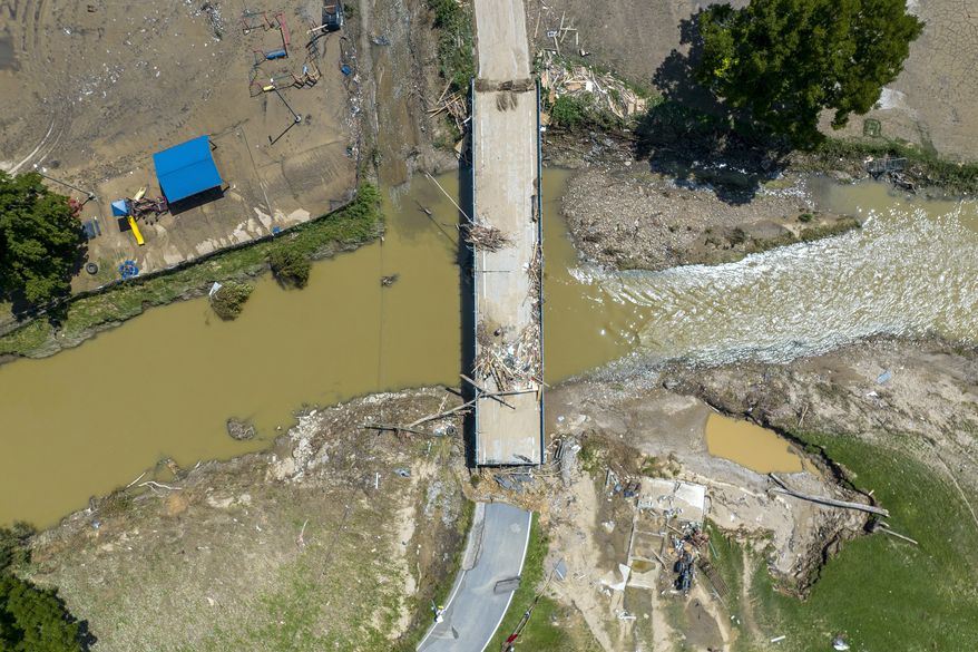 A bridge along KY-3351 over Troublesome Creek near Ary in Perry County, Ky., remains damaged Tuesday, Aug. 2, 2022, following flooding the week before that devastated many counties in Eastern Kentucky. (Ryan C. Hermens/Lexington Herald-Leader via AP, File)