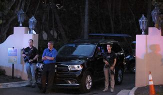 Armed Secret Service agents stand outside an entrance to former President Donald Trump&#39;s Mar-a-Lago estate, late Monday, Aug. 8, 2022, in Palm Beach, Fla. Trump said in a lengthy statement that the FBI was conducting a search of his Mar-a-Lago estate and asserted that agents had broken open a safe. (AP Photo/Terry Renna)