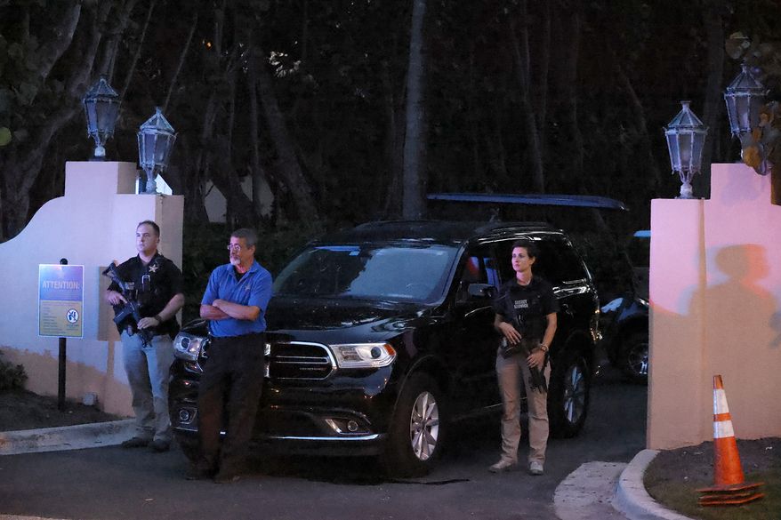 Armed Secret Service agents stand outside an entrance to former President Donald Trump&#39;s Mar-a-Lago estate, late Monday, Aug. 8, 2022, in Palm Beach, Fla. Trump said in a lengthy statement that the FBI was conducting a search of his Mar-a-Lago estate and asserted that agents had broken open a safe. (AP Photo/Terry Renna) ** FILE **