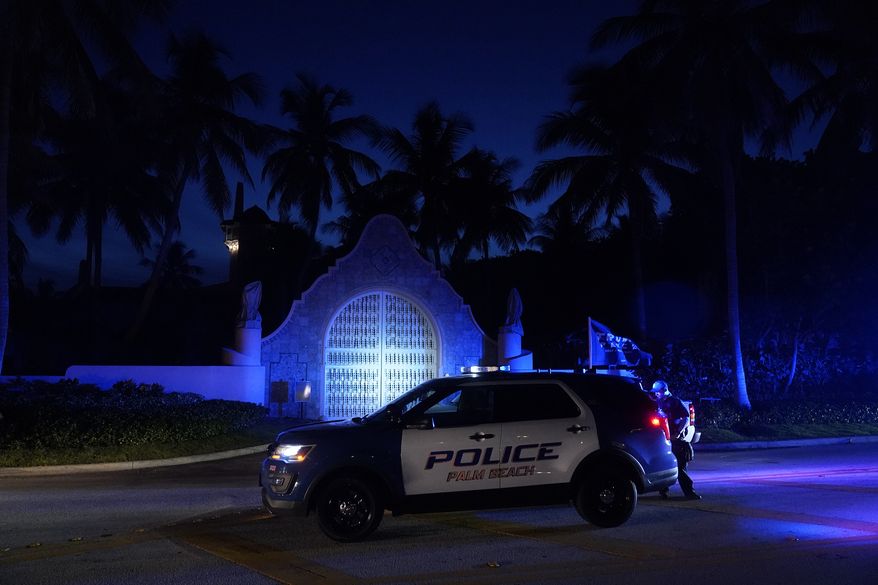 Police stand outside an entrance to former President Donald Trump&#39;s Mar-a-Lago estate, Monday, Aug. 8, 2022, in Palm Beach, Fla. Trump said in a lengthy statement that the FBI was conducting a search of his Mar-a-Lago estate and asserted that agents had broken open a safe. (AP Photo/Wilfredo Lee)