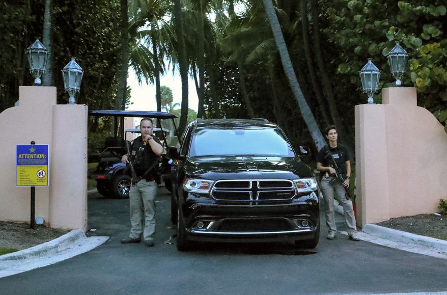 Secret Service agents stand at the gate of Mar-a-Lago after the FBI issued warrants at the Palm Beach, Fla., estate, Monday, Aug. 8, 2020. Former President Donald Trump said in a lengthy statement that the FBI was conducting a search of his Mar-a-Lago estate and asserted that agents had broken open a safe. (Damon Higgins/Palm Beach Daily News via AP)