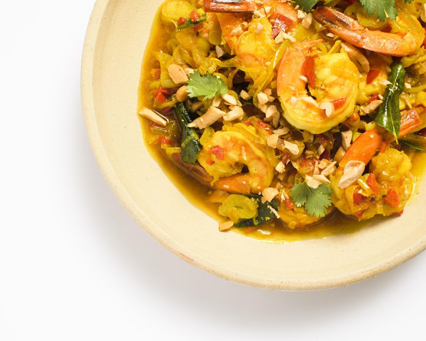 This image released by Milk Street shows a recipe for Stir-Fried Turmeric Shrimp with Shallots and Chilies. (Milk Street via AP)