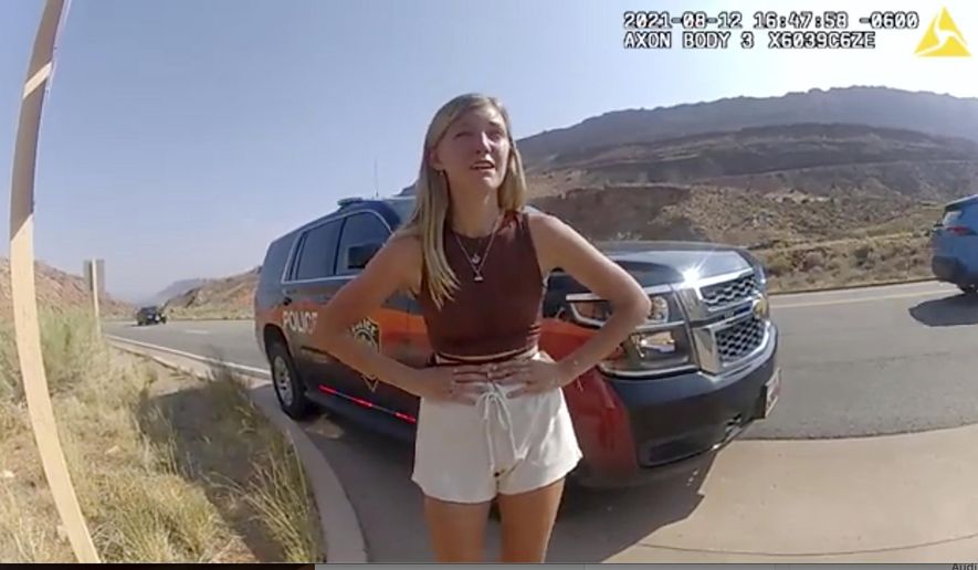 In this image taken from police body camera video provided by The Moab Police Department, Gabrielle "Gabby" Petito talks to a police officer after police pulled over the van she was traveling in with her boyfriend, Brian Laundrie, near the entrance to Arches National Park on Aug. 12, 2021. The family of Petito filed a notice of claim Monday, Aug. 8, 2022, of plans to file a wrongful death lawsuit against the tourist town of Moab, Utah, over police officers' handling of an encounter with Petito and her boyfriend weeks she was found dead in Wyoming. (The Moab Police Department via AP, File)
