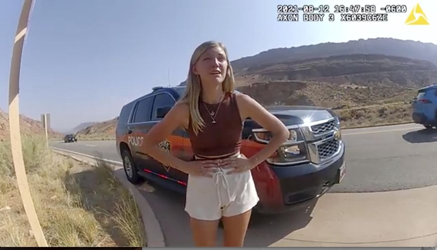 In this image taken from police body camera video provided by The Moab Police Department, Gabrielle "Gabby" Petito talks to a police officer after police pulled over the van she was traveling in with her boyfriend, Brian Laundrie, near the entrance to Arches National Park on Aug. 12, 2021. The family of Petito filed a notice of claim Monday, Aug. 8, 2022, of plans to file a wrongful death lawsuit against the tourist town of Moab, Utah, over police officers' handling of an encounter with Petito and her boyfriend weeks she was found dead in Wyoming. (The Moab Police Department via AP, File)