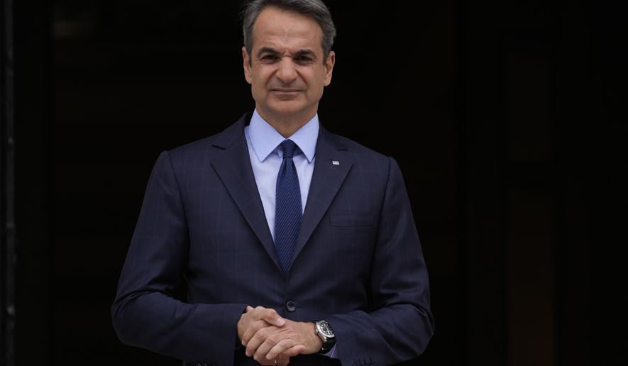 Greece&#39;s Prime Minister Kyriakos Mitsotakis stands outside Maximos Mansion in Athens, May 6, 2022. Mitsotakis insists he was unaware that the country&#39;s intelligence service had been bugging the mobile phone of an opposition politician for three months, and that had he known, he would not have allowed it. The comments came in a televised address to the nation by Mitsotakis, on Monday, Aug. 8. (AP Photo/Thanassis Stavrakis, File)