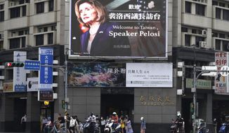 People walk past a billboard welcoming U.S. House Speaker Nancy Pelosi, in Taipei, Taiwan, Aug 3, 2022. Days after Ayman al-Zawahiri was killed in Kabul, China staged large-scale military exercises and threatened to cut off contacts with the U.S. over House Speaker Nancy Pelosi&#39;s visit to Taiwan. (AP Photo/Chiang Ying-ying, File)