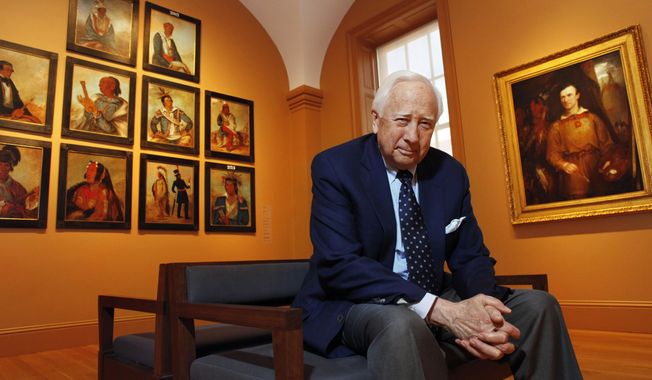 Historian and author David McCullough poses with art by George Catlin, one of the artists featured in his new book, &amp;quot;The Greater Journey,&amp;quot; at the National Portrait Gallery, in Washington on May 13, 2011. McCullough, the Pulitzer Prize-winning author whose lovingly crafted narratives on subjects ranging from the Brooklyn Bridge to Presidents John Adams and Harry Truman made him among the most popular and influential historians of his time, died Sunday in Hingham, Massachusetts. He was 89. (AP Photo/Jacquelyn Martin, File)