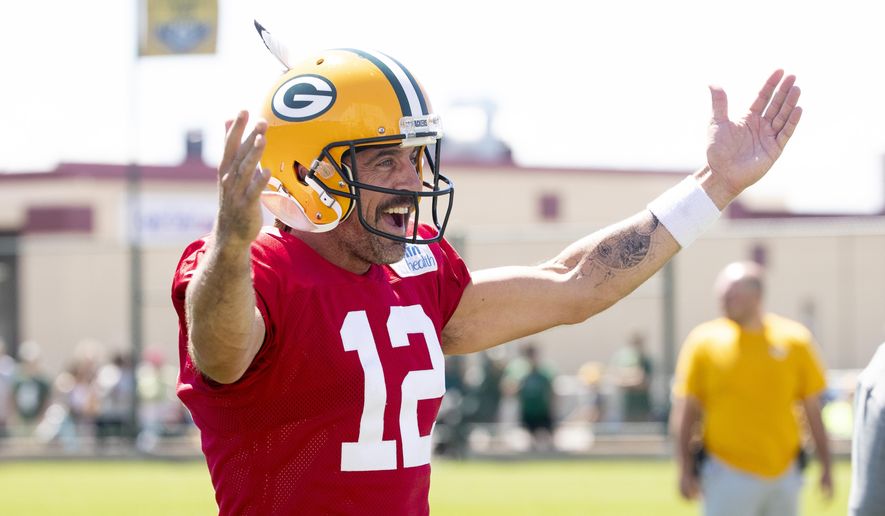 Green Bay Packers quarterback Aaron Rodgers (12) reacts during NFL football training camp on Thursday, Aug. 4, 2022, at Ray Nitschke Field in Ashwaubenon, Wis. (Samantha Madar/The Post-Crescent via AP)
