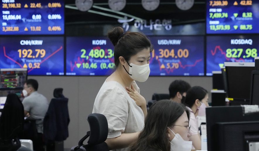 Currency traders watch monitors at the foreign exchange dealing room of the KEB Hana Bank headquarters in Seoul, South Korea, Monday, Aug. 8, 2022. Asian stocks were mixed Monday after strong U.S. jobs data cleared the way for more interest rate hikes and Chinese exports rose by double digits. (AP Photo/Ahn Young-joon)