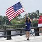 Adriane Shochet stands on a bridge outside the entrance to former President Donald Trump&#39;s Mar-a-Lago estate, Tuesday, Aug. 9, 2022, in Palm Beach, Fla. The FBI searched Trump&#39;s Mar-a-Lago estate as part of an investigation into whether he took classified records from the White House to his Florida residence, people familiar with the matter said Monday. (AP Photo/Lynne Sladky)
