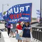 Trump supporters carry flags near Mar-a-Lago in Palm Beach, Fla., on August 9, 2022. (Greg Lovett/The Palm Beach Post via AP)