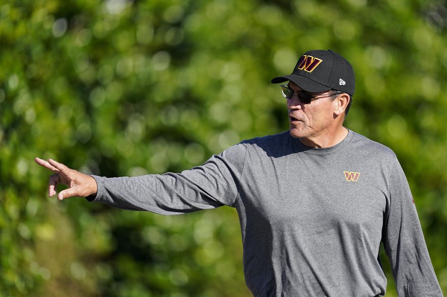 Washington Commanders head coach Ron Rivera waves to fans as he arrives for practice at the NFL football team&#39;s training facility, Tuesday, Aug. 9, 2022, in Ashburn, Va. (AP Photo/Alex Brandon)