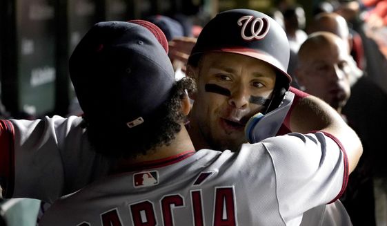 Washington Nationals&#39; Luis Garcia hugs Joey Meneses in the dugout after Meneses&#39; two-run home run off Chicago Cubs relief pitcher Mark Leiter Jr. during the eighth inning of a baseball game Tuesday, Aug. 9, 2022, in Chicago. (AP Photo/Charles Rex Arbogast)