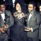 Singer Diana Ross, second from left, joins songwriters, from left, Lamont Dozier, Brian Holland and Eddie Holland after the writing team was inducted into the Rock and Roll Hall of Fame in New York on Jan. 17, 1990. Dozier, of the celebrated Holland-Dozier-Holland team that wrote and produced “You Can’t Hurry Love,” “Heat Wave” and dozens of other hits and helped make Motown an essential record company of the 1960s and beyond, has died at age 81.  (AP Photo/Ron Frehm, File)