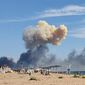 Rising smoke can be seen from the beach at Saky after explosions were heard from the direction of a Russian military airbase near Novofedorivka, Crimea, Tuesday Aug. 9, 2022. The explosion of munitions caused a fire at a military air base in Russian-annexed Crimea Tuesday but no casualties or damage to stationed warplanes, Russia&#39;s Defense Ministry said. (UGC via AP)