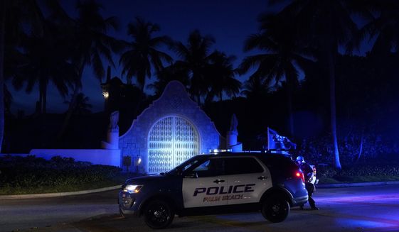 Police stand outside an entrance to former President Donald Trump&#39;s Mar-a-Lago estate, Monday, Aug. 8, 2022, in Palm Beach, Fla. The FBI search of Trump’s Mar-a-Lago estate marked a dramatic and unprecedented escalation of the law enforcement scrutiny of the former president, but the Florida operation is just one part of one investigation related to Trump and his time in office. (AP Photo/Wilfredo Lee, File)