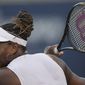 Serena Williams, of the United States, follows through on a return to Belinda Bencic, of Switzerland, during the National Bank Open tennis tournament Wednesday, Aug. 10, 2022, in Toronto. (Nathan Denette/The Canadian Press via AP)
