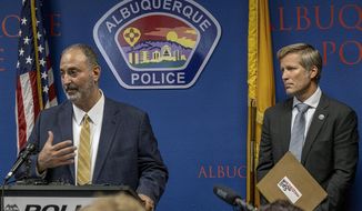 Ahmad Assed, president of the Islamic Center of New Mexico, left, speaks at a news conference to announce the arrest of Muhammad Syed, a suspect in the recent murders of Muslim men in Albuquerque, N.M., as Albuquerque Mayor Tim Keller listens, at right, Tuesday, Aug. 9, 2022. (Adolphe Pierre-Louis/The Albuquerque Journal via AP)