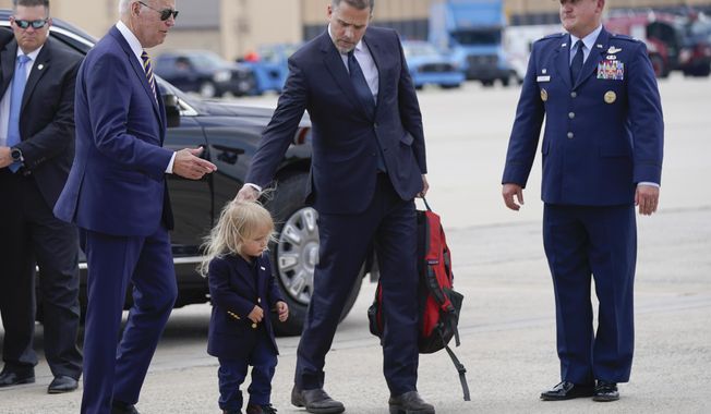 President Joe Biden walks with his son Hunter Biden and grandson Beau Biden to board Air Force One at Andrews Air Force Base, Md., Wednesday, Aug. 10, 2022. The President is traveling to Kiawah Island, S.C., for vacation. (AP Photo/Manuel Balce Ceneta)