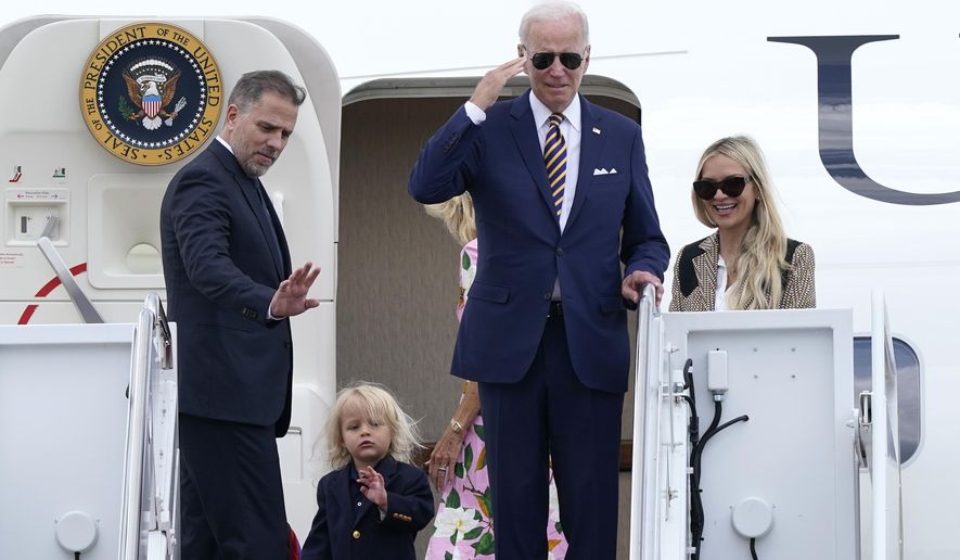 President Joe Biden, center, returns a salute as he is joined by, from left, son Hunter Biden, grandson Beau Biden, first lady Jill Biden, obscured, and daughter-in-law Melissa Cohen, as they stand at the top of the steps of Air Force One at Andrews Air Force Base, Md., Wednesday, Aug. 10, 2022. They are heading to South Carolina for a week-long vacation on Kiawah Island. (AP Photo/Susan Walsh) **FILE**