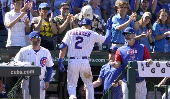 Chicago Cubs manager David Ross, right, greets Nico Hoerner after Horner&#39;s homer off Washington Nationals starting pitcher Josiah Gray during the seventh inning of a baseball game Wednesday, Aug. 10, 2022, in Chicago. (AP Photo/Charles Rex Arbogast)
