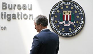 FBI Director Christopher Wray arrives at a news conference, Wednesday, Aug. 10, 2022, in Omaha, Neb. (AP Photo/Charlie Neibergall)