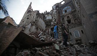 Yemeni people inspect a rains-collapsed UNESCO-listed building in the old city of Sanaa, Yemen, Wednesday, Aug 10, 2022. (AP Photo/Hani Mohammed)