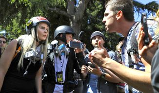 In this April 27, 2017 file photo, demonstrators, sharing opposing views, argue during a rally in Berkeley, Calif., near the University of California campus, to show support for free speech and to condemn the views of Ann Coulter and her supporters. Coulter&#39;s speech was cancelled. (AP Photo/Marcio Jose Sanchez, File)