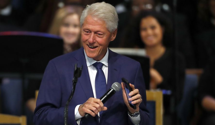 Former President Bill Clinton smiles as he plays a recording of Aretha Franklin on his phone during the funeral service for Franklin at Greater Grace Temple, Friday, Aug. 31, 2018, in Detroit. (AP Photo/Paul Sancya) **FILE**