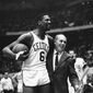 Bill Russell, left, star of the Boston Celtics is congratulated by coach Arnold &quot;Red&quot; Auerbach after scoring his 10,000th point in the NBA game against the Baltimore Bullets in Boston Garden on Dec. 12, 1964. The NBA great Bill Russell has died at age 88. His family said on social media that Russell died on Sunday, July 31, 2022. Russell anchored a Boston Celtics dynasty that won 11 titles in 13 years. (AP Photo/Bill Chaplis, file)