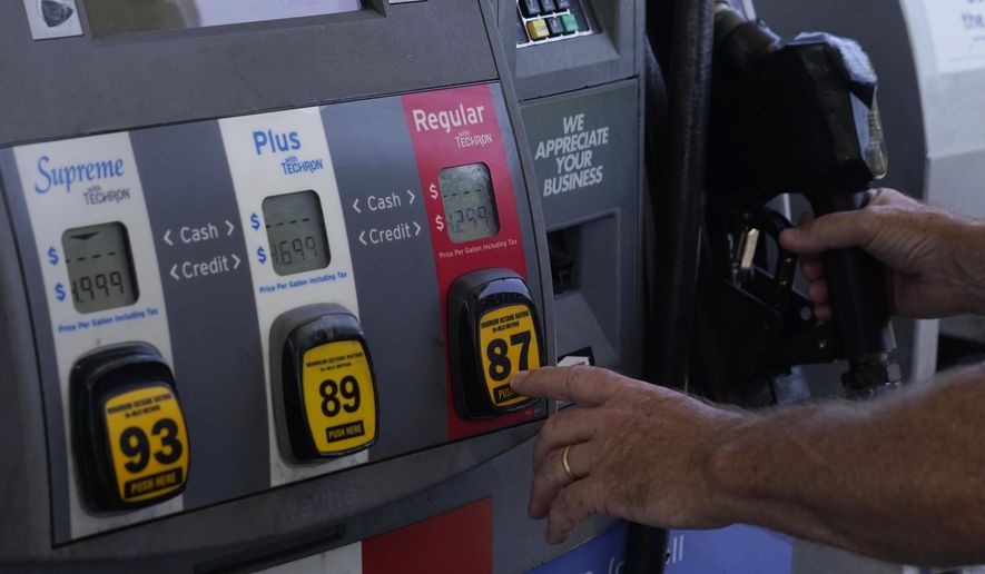 A customer pumps gas at an Exxon gas station, Tuesday, May 10, 2022, in Miami. Gasoline prices are sliding back toward the $4 mark for the first time in more than five months — good news for consumers who are struggling with high prices for many other essentials. (AP Photo/Marta Lavandier)