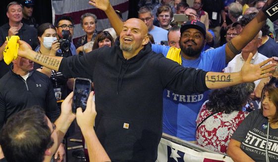 Pennsylvania Lt. Gov. John Fetterman, the Democratic nominee for the state&#39;s U.S. Senate seat, center, poses for a selfie with supporters after speaking at a rally in Erie, Pa., on Friday, Aug. 12, 2022. (AP Photo/Gene J. Puskar)