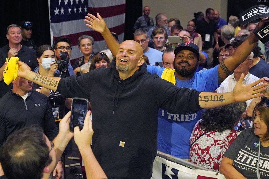 Pennsylvania Lt. Gov. John Fetterman, the Democratic nominee for the state&#39;s U.S. Senate seat, center, poses for a selfie with supporters after speaking at a rally in Erie, Pa., on Friday, Aug. 12, 2022. (AP Photo/Gene J. Puskar)