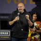 Pennsylvania Lt. Gov. John Fetterman, the Democratic nominee for the state&#39;s U.S. Senate seat, speaks after being introduced by his wife Gisele Barreto Fetterman, right, during a rally in Erie, Pa., on Friday, Aug. 12, 2022. (AP Photo/Gene J. Puskar)