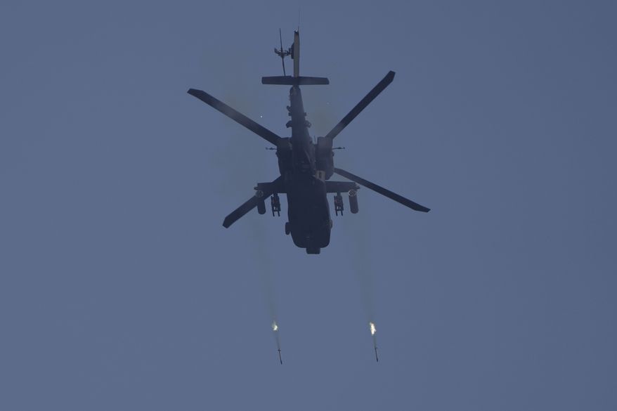 A U.S. Army AH-64 Apache attack helicopter fires rockets to engage a target during Super Garuda Shield 2022 joint military exercises in Baturaja, South Sumatra, Indonesia, Friday, Aug. 12, 2022. The United States and Indonesian militaries conducted the annual combat exercises on Indonesia&#x27;s Sumatra island, joined for the first time by participants from other partner nations including Australia, Japan and Singapore, signaling stronger ties amid growing maritime activity by China in the Indo-Pacific region. (AP Photo/Dita Alangkara) **FILE**