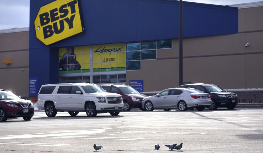 FILE - Pigeons walk across a parking lot outside the Best Buy store on Dec. 10, 2020, in Manchester, N.H. Best Buy, the nation&#x27;s largest consumer electronics chain, is trimming jobs in an effort to adjust to new changes in consumer behavior as the virus wanes. The company declined to say how many jobs it was cutting, but The Wall Street Journal, which was first to report the news Friday, Aug. 12, 2022, estimated it involved hundreds of jobs at the store level. (AP Photo/Charles Krupa, File)