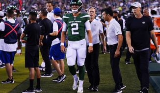 New York Jets&#x27; Zach Wilson walks on the sidelines after he is taken off the field following an injury during the first half of a preseason NFL football game against the Philadelphia Eagles on Friday, Aug. 12, 2022, in Philadelphia. (AP Photo/Matt Rourke)