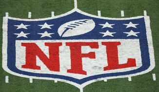 The NFL logo is seen at a stadium on Nov. 2, 2020, in East Rutherford, N.J. Hundreds of Black NFL retirees denied payouts in the $1 billion concussion settlement now qualify for awards after their tests were rescored to eliminate racial bias.Changes to the settlement made last year are meant to make the tests race-blind.  (AP Photo/Adam Hunger, File)