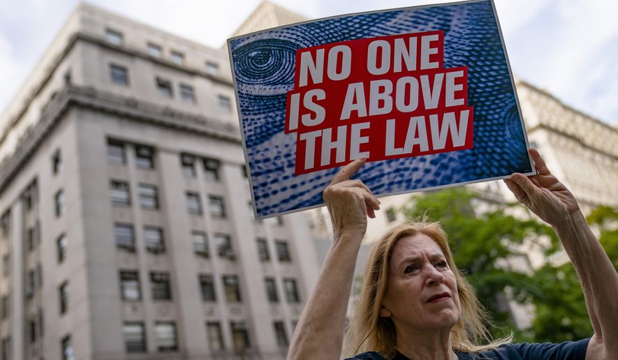 Protestors gather before the arrival of the Trump Organization&#39;s former Chief Financial Officer Allen Weisselberg at court, Friday, Aug. 12, 2022, in New York. (AP Photo/John Minchillo)