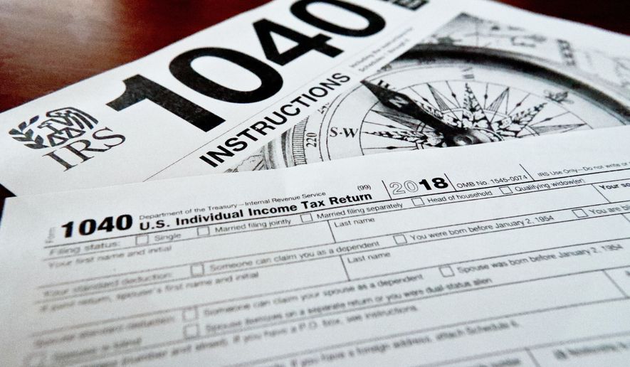 Internal Revenue Service taxes forms are seen on Feb. 13, 2019. The flagship climate change and health care bill passed by Democrats and soon to be signed by President Biden will have U.S. taxpayers one step closer to a government-operated electronic free-file tax return system. (AP Photo/Keith Srakocic, File)