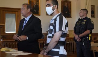 Hadi Matar, 24, center, listens to his public defense attorney Nathaniel Barone, left, addresses the judge while being arraigned in the Chautauqua County Courthouse in Mayville, NY., Saturday, Aug. 13, 2022. Matar, accused of carrying out a stabbing attack against “Satanic Verses” author Salman Rushdie, has entered a not-guilty plea on charges of attempted murder and assault. (AP Photo/Gene J. Puskar)
