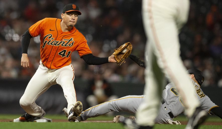 San Francisco Giants third baseman Wilmer Flores (41) catches the throw in time to force out Pittsburgh Pirates&#39; Josh VanMeter (26) at third base during the eighth inning of a baseball game Friday, Aug. 12, 2022, in San Francisco. (AP Photo/D. Ross Cameron)