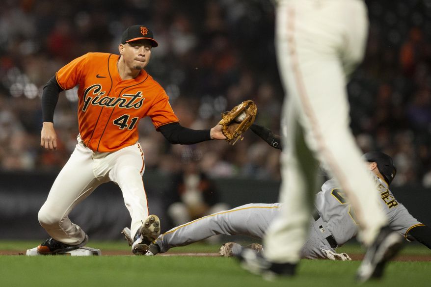 San Francisco Giants third baseman Wilmer Flores (41) catches the throw in time to force out Pittsburgh Pirates&#39; Josh VanMeter (26) at third base during the eighth inning of a baseball game Friday, Aug. 12, 2022, in San Francisco. (AP Photo/D. Ross Cameron)