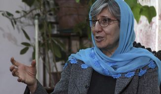 FILE - Sima Samar, a prominent activist and physician, who has been fighting for women&#39;s rights in Afghanistan for the past 40 years, gives an interview to The Associated Press, at her house in Kabul, Afghanistan, on March 6, 2021. A year after the Taliban takeover of Afghanistan, prominent Afghan rights activist Sima Samar is still heartbroken over what happened to her country. (AP Photo/Rahmat Gul)