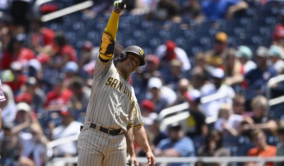 San Diego Padres&#39; Juan Soto gestures after he singled during the third inning of a baseball game against the Washington Nationals, Sunday, Aug. 14, 2022, in Washington. (AP Photo/Nick Wass)