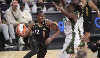 Las Vegas Aces guard Chelsea Gray (12) passes around Seattle Storm&#39;s Tina Charles during the first half of a WNBA basketball game Sunday, Aug. 14, 2022, in Las Vegas. (AP Photo/Sam Morris) **FILE**