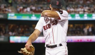 Boston Red Sox pitcher Michael Wacha wipes his face as he walks off the mound against the New York Yankees during the seventh inning at Fenway Park, Sunday, Aug. 14, 2022, in Boston. (AP Photo/Paul Connors)