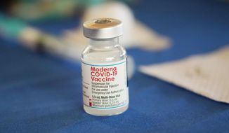 A vial of Moderna COVID-19 vaccine rests on a table at an inoculation station next to Jackson State University in Jackson, Miss., on July 19, 2022. British health authorities have authorized an updated version of Moderna&#39;s coronavirus vaccine that aims to protect against the original virus and the omicron variant. (AP Photo/Rogelio V. Solis)