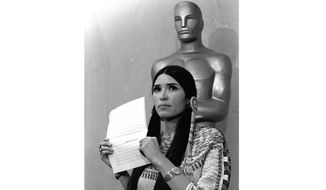 Sacheen Littlefeather appears at the Academy Awards ceremony to announce that Marlon Brando was declining his Oscar as best actor for his role in &amp;quot;The Godfather,&amp;quot; on March 27, 1973. The move was meant to protest Hollywood&#39;s treatment of American Indians. Nearly 50 years later, the Academy of Motion Pictures Arts and Sciences has apologized to Littlefeather for the abuse she endured. The Academy Museum of Motion Pictures on Monday said that it will host Littlefeather, now 75, for an evening of “conversation, healing and celebration” on Sept. 17. (AP Photo, File)
