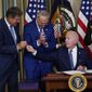 President Joe Biden hands the pen he used to sign the Democrats&#39; landmark climate change and health care bill to Sen. Joe Manchin, D-W.Va., in the State Dining Room of the White House in Washington, Tuesday, Aug. 16, 2022. (AP Photo/Susan Walsh)